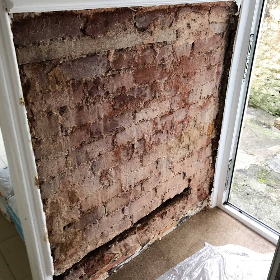 Wall stripped back to exposed brickwork